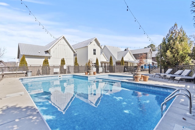 view of pool with a residential view, fence, a fenced in pool, and a patio