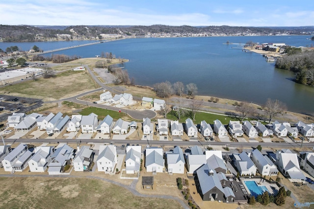 drone / aerial view featuring a water view and a residential view