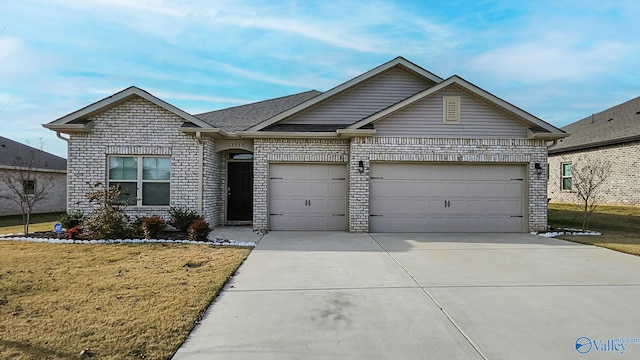 view of front of property featuring a garage and a front lawn