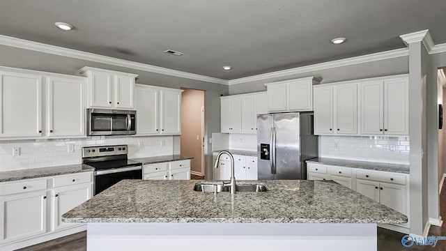 kitchen featuring white cabinetry, sink, an island with sink, and appliances with stainless steel finishes