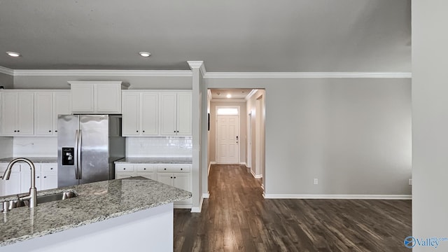 kitchen with white cabinets, dark hardwood / wood-style floors, sink, and stainless steel refrigerator with ice dispenser