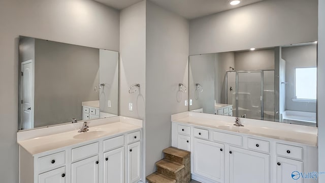 bathroom with vanity and independent shower and bath