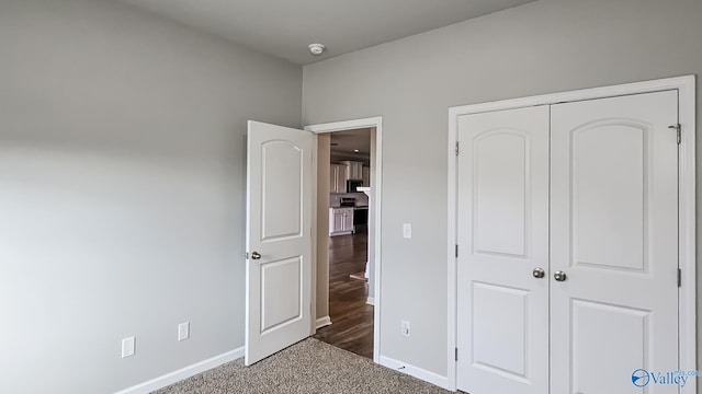 unfurnished bedroom with carpet and a closet