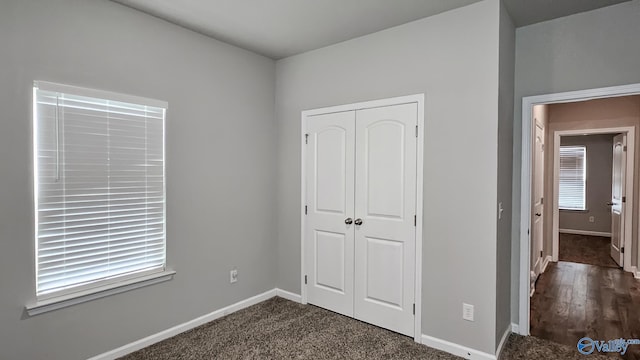 unfurnished bedroom featuring a closet and dark hardwood / wood-style floors