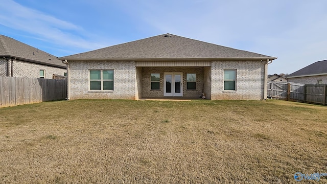 rear view of property featuring a yard