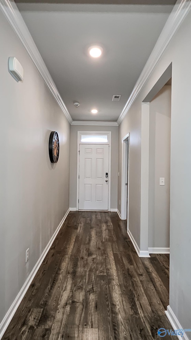 hallway with dark hardwood / wood-style flooring and ornamental molding