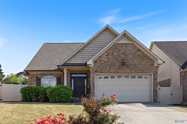 22222 Merlot Dr, Athens, AL 35613 - craftsman house featuring a gate, fence, concrete driveway, brick siding, and a garage