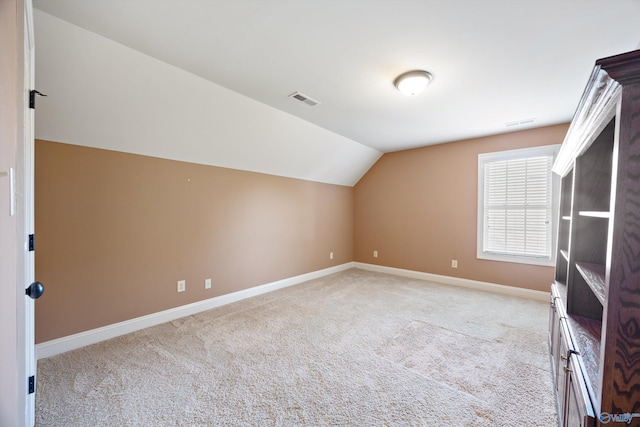 22222 Merlot Dr, Athens, AL 35613 - bonus room with visible vents, light carpet, vaulted ceiling, and baseboards