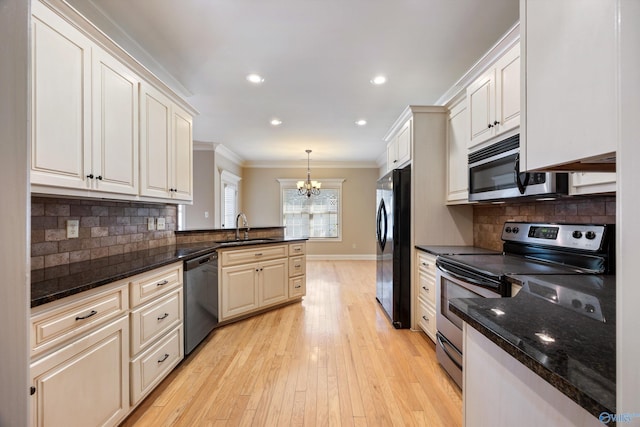 22222 Merlot Dr, Athens, AL 35613 - kitchen featuring a sink, ornamental molding, stainless steel appliances, a peninsula, and a notable chandelier