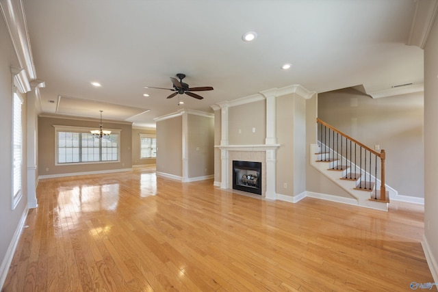 22222 Merlot Dr, Athens, AL 35613 - unfurnished living room featuring a fireplace with flush hearth, ornamental molding, and ceiling fan with notable chandelier