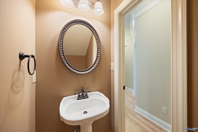 22222 Merlot Dr, Athens, AL 35613 - bathroom featuring baseboards, wood finished floors, and a sink