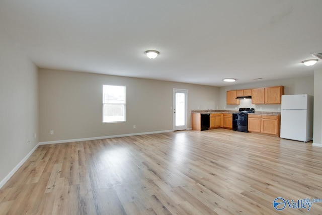 kitchen with light wood-type flooring and black appliances