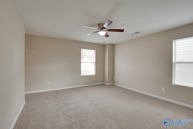 empty room with light colored carpet and ceiling fan