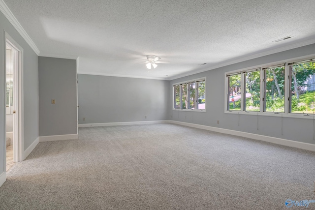 unfurnished room with visible vents, crown molding, baseboards, ceiling fan, and light carpet