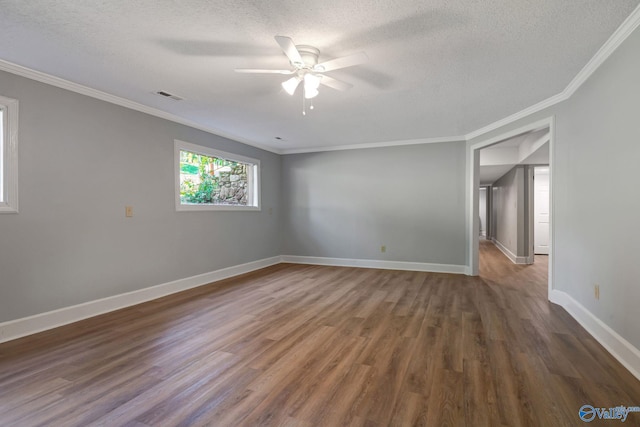 spare room featuring wood finished floors, baseboards, and a textured ceiling