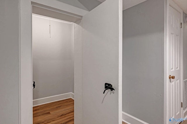 bathroom featuring wood finished floors and baseboards