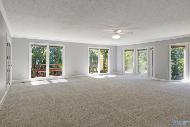 carpeted empty room with baseboards, a textured ceiling, and a ceiling fan