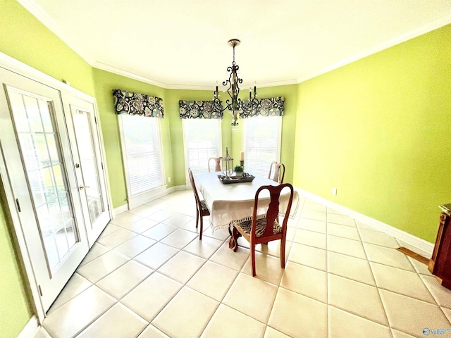 dining space featuring crown molding, light tile patterned flooring, an inviting chandelier, and french doors