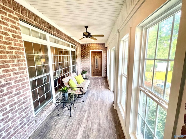 sunroom / solarium featuring wood ceiling and ceiling fan