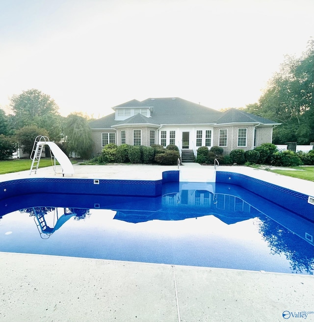 view of swimming pool with a water slide