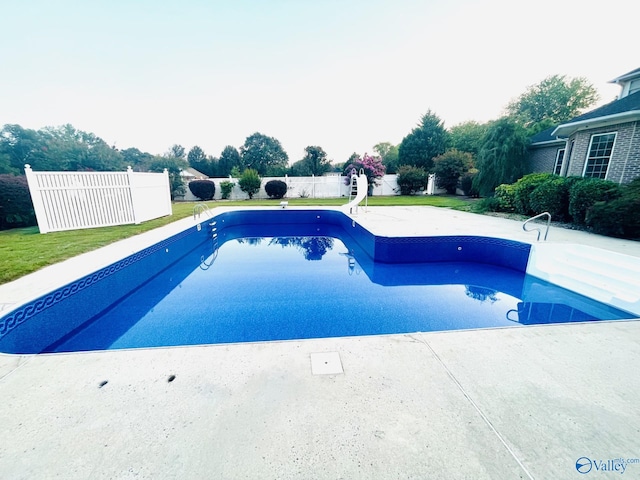 view of pool featuring a patio, a lawn, and a water slide