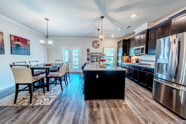 207 Jubilee Cir SE, Huntsville, AL 35803 - kitchen featuring stainless steel appliances, a center island, french doors, light stone counters, and crown molding