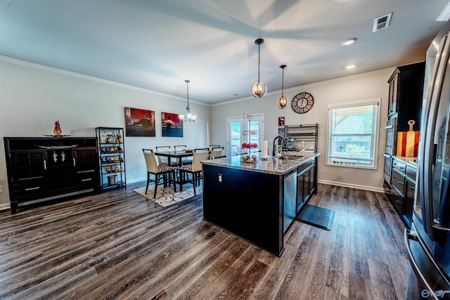 207 Jubilee Cir SE, Huntsville, AL 35803 - kitchen featuring dark wood-type flooring, light stone countertops, a center island with sink, a chandelier, and ornamental molding