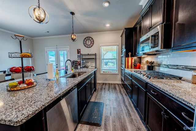 207 Jubilee Cir SE, Huntsville, AL 35803 - kitchen with stainless steel appliances, dark wood finished floors, plenty of natural light, decorative backsplash, and crown molding