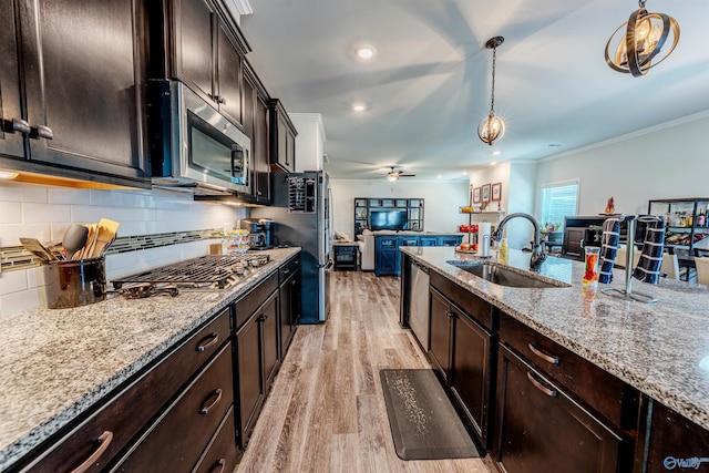 207 Jubilee Cir SE, Huntsville, AL 35803 - kitchen with stainless steel appliances, open floor plan, light wood-style flooring, ceiling fan, and pendant lighting