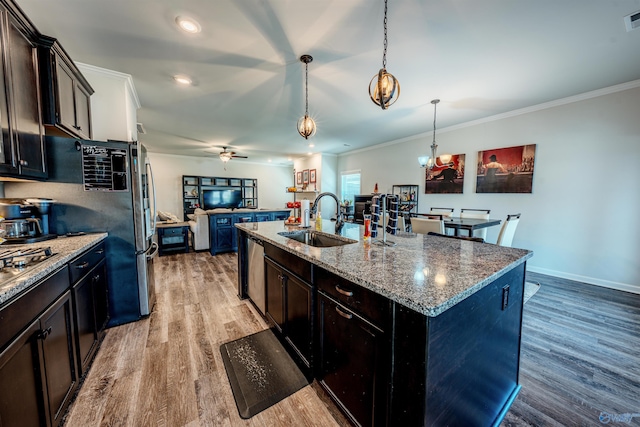 207 Jubilee Cir SE, Huntsville, AL 35803 - kitchen with light wood-style flooring, a kitchen island with sink, stone countertops, crown molding, and open floor plan