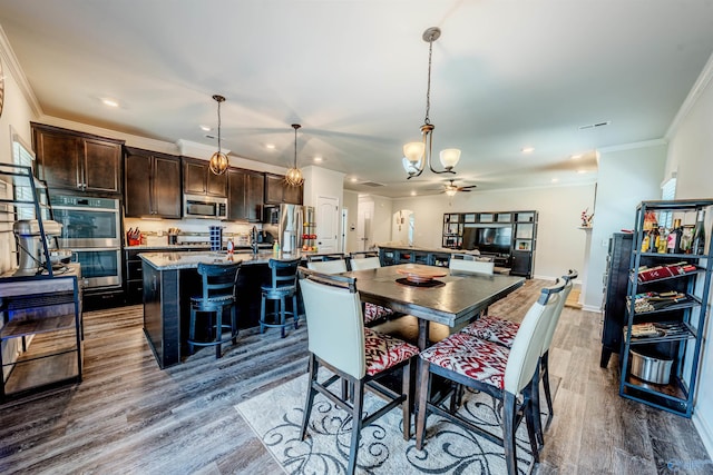 207 Jubilee Cir SE, Huntsville, AL 35803 - dining room with dark wood-type flooring, ornamental molding, a chandelier, and recessed lighting
