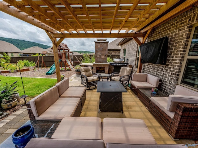 207 Jubilee Cir SE, Huntsville, AL 35803 - fenced backyard with an outdoor living space with a fireplace, a patio, a pergola, and a playground