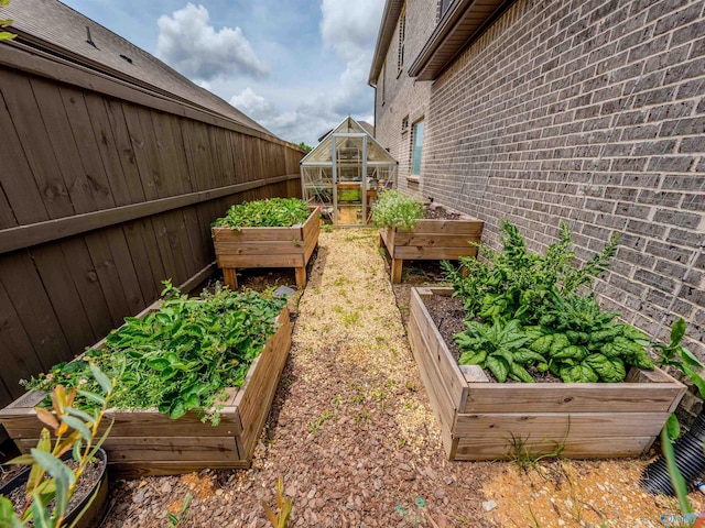207 Jubilee Cir SE, Huntsville, AL 35803 - view of yard with a garden, an exterior structure, and an outdoor structure