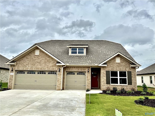 121 Headen Ln, Huntsville, AL 35811 - view of front of home featuring driveway, brick siding, a front yard, roof with shingles, and an attached garage