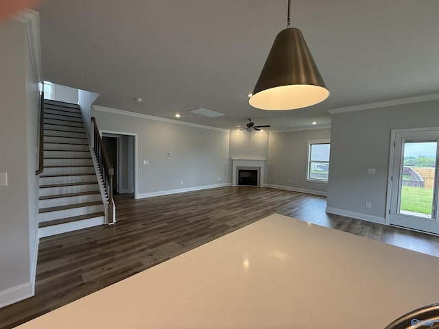 121 Headen Ln, Huntsville, AL 35811 - unfurnished living room featuring ornamental molding, baseboards, dark wood-style floors, ceiling fan, and stairs