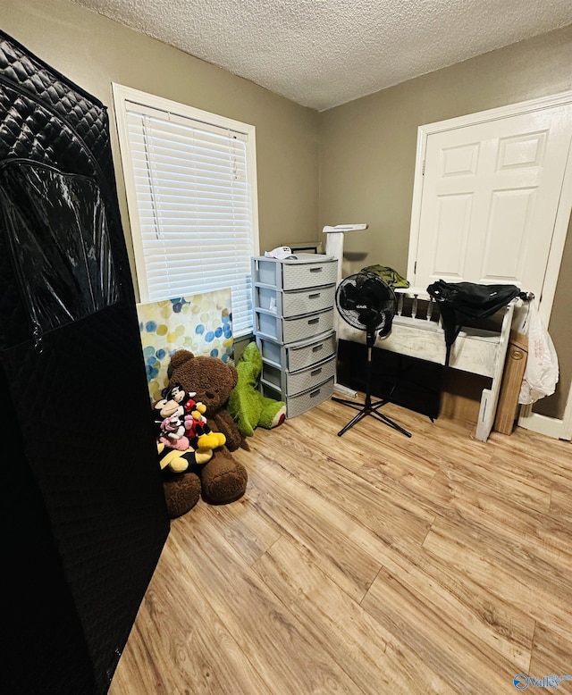 26 Prospect St, Town Creek, AL 35672 - bedroom featuring wood finished floors and a textured ceiling