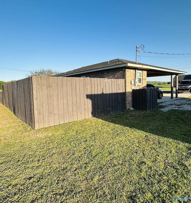 26 Prospect St, Town Creek, AL 35672 - view of home's exterior featuring brick siding, a lawn, and fence