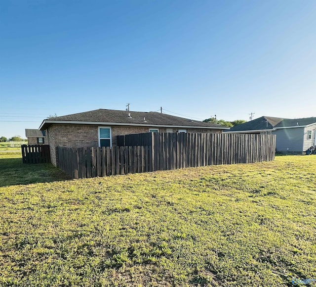 26 Prospect St, Town Creek, AL 35672 - exterior space with fence, brick siding, and a yard