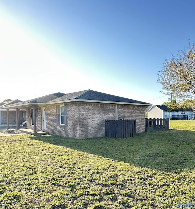 26 Prospect St, Town Creek, AL 35672 - view of property exterior with brick siding, a yard, and fence