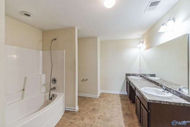 bathroom featuring washtub / shower combination and vanity