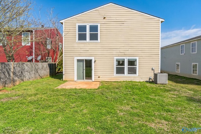 back of property with a patio, central AC unit, and a lawn