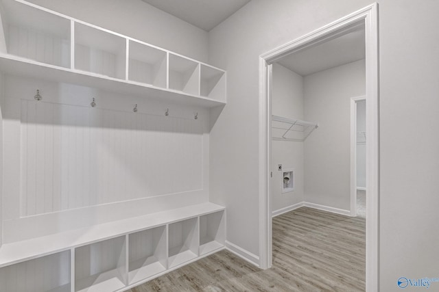 mudroom featuring light wood finished floors and baseboards