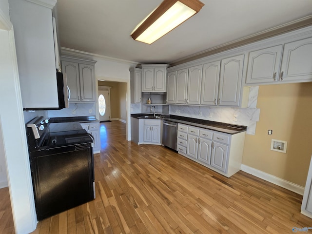 kitchen featuring sink, crown molding, white cabinetry, stainless steel appliances, and light wood-type flooring