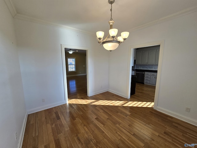 unfurnished dining area featuring ornamental molding, dark hardwood / wood-style flooring, and a notable chandelier