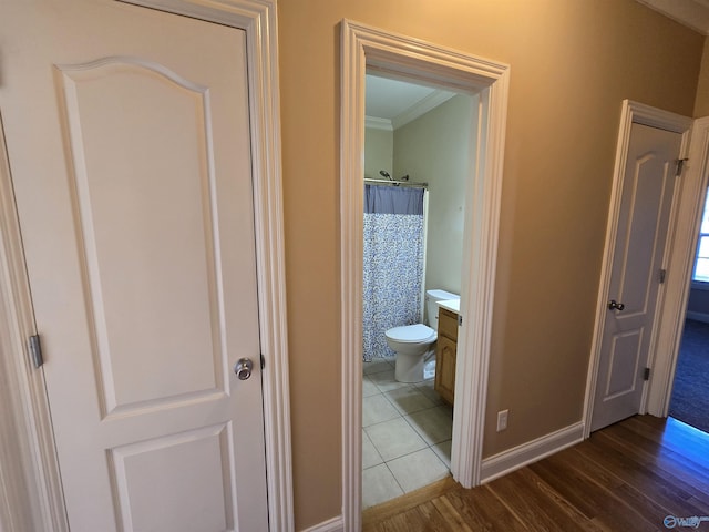 bathroom with walk in shower, toilet, crown molding, wood-type flooring, and vanity