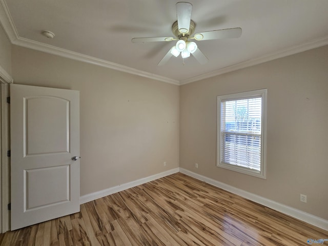 empty room with ceiling fan, ornamental molding, and light hardwood / wood-style floors