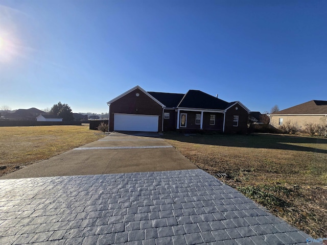 ranch-style house featuring a garage and a front yard