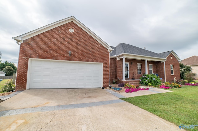 view of front of property featuring a garage and a front lawn