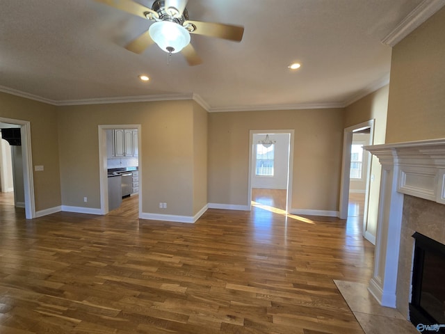 unfurnished living room with dark wood-type flooring, ornamental molding, and ceiling fan