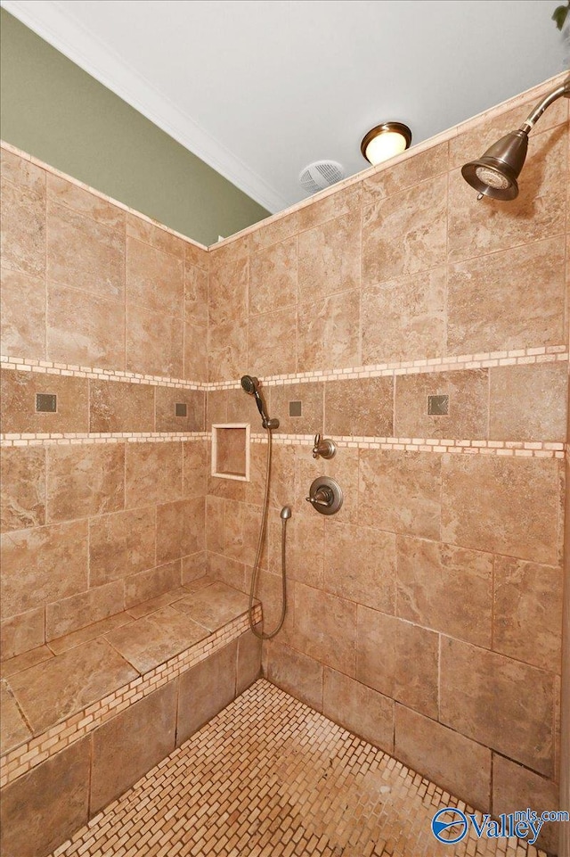 83 James Rd, Hartselle, AL 35640 - full bathroom featuring crown molding and a tile shower